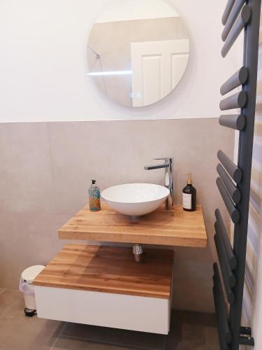a bathroom with a sink and a mirror at Hotel Via Vita in Treuchtlingen