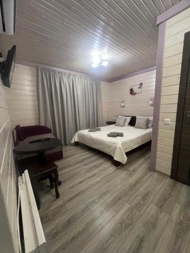 a bedroom with a bed and a desk in it at Фенікс in Yaremche