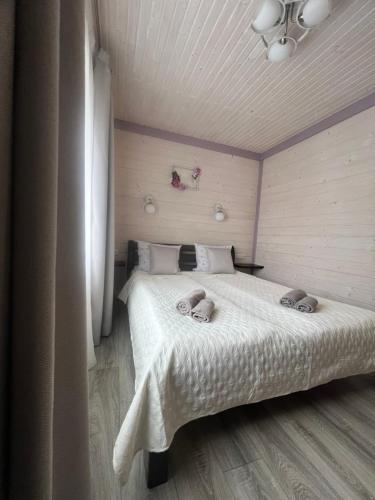 a bedroom with a bed with two towels on it at Фенікс in Yaremche