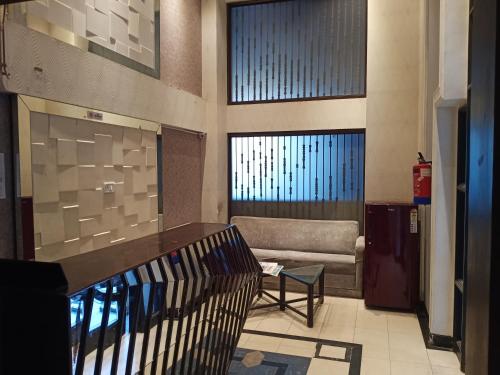 a lobby with a couch and a table in a building at Indiana Classic in Jaipur