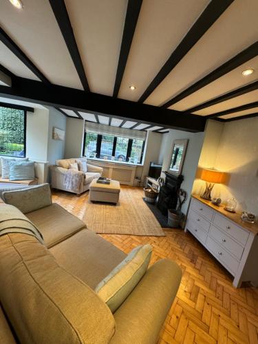 a living room with a couch and a table at Thornton House Private Country House Thornton Hough Entire House sleeps 6 in Wirral