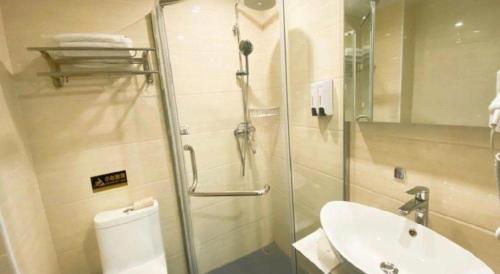 a bathroom with a shower and a toilet and a sink at 7 Days Premium Hotel Ji'an Taihe Gongnongbing Avenue in Ji'an