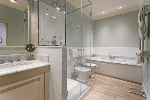 a bathroom with two sinks and a toilet and a shower at Palazzo Niccolini al Duomo Residenza D'Epoca in Florence