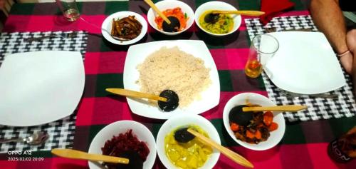 a table with bowls of food on a table at Peaceful Peak in Kandy