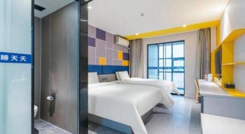 a hotel room with two beds and a window at 7 Days Inn Guangrao Bus Station in Dongying