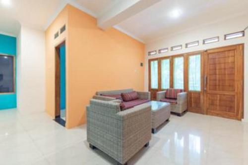a living room with a couch and a table at OYO Life 92127 Skyland Pasteur in Bandung
