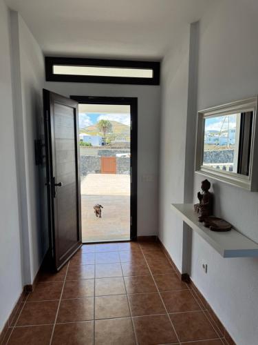 a hallway with a door with a dog looking outside at Vineyard House in La Vegueta