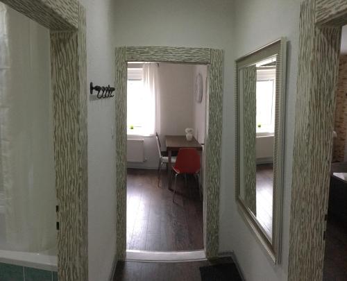 a hallway with two mirrors and a table in a room at Apartments Centrum in Rožnov pod Radhoštěm