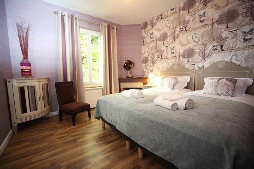 a bedroom with two beds with towels on them at Domaine de la Caillardière in Gien