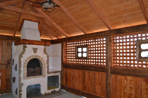 a room with a fireplace and a wooden ceiling at Aura Karpat in Bukovel