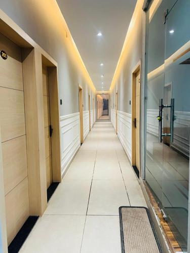 an empty hallway of a building with doors and windows at Hotel SS Royal in Lucknow