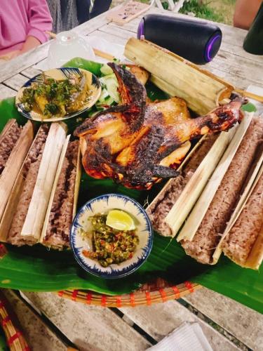 a plate of food on a table with different foods at Đông Giang Sky Villa in A Sơ Ră Amo
