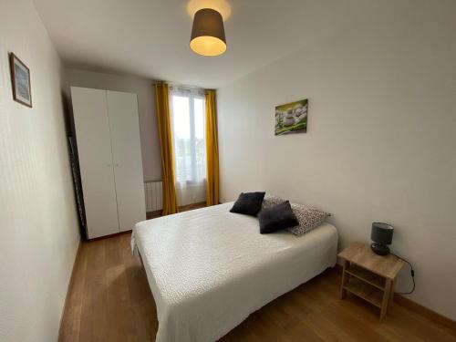 a bedroom with a white bed and a window at Cosy F2 Fresnes-Près de Paris, Orly et Rungis in Fresnes