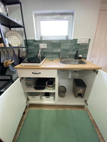a small kitchen with a sink and a window at Casa Vinny in Aljezur