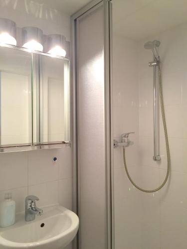 a bathroom with a shower and a sink at Haus Daheim in Oberstaufen