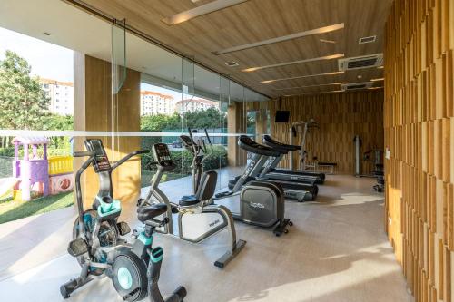 a row of exercise bikes in a gym at A LUX- VERANDA PATTAYA - Residence in Jomtien Beach