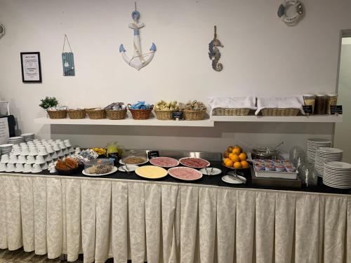 a buffet with many different types of food on a table at Hotel AnnaMare in Rimini