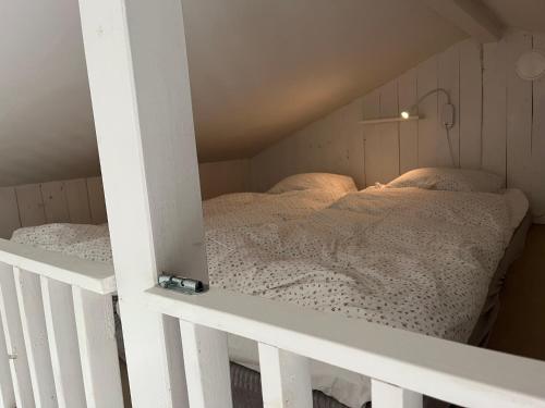a bedroom with two beds in a attic at Strandboende in Beddinge Strand