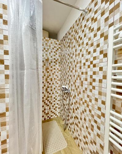 a bathroom with a shower with a white shower curtain at Green Village Life in Katun