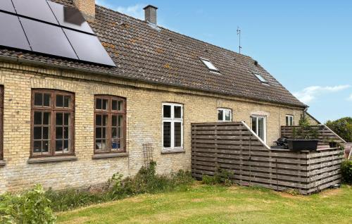 an external view of a house with a solar roof at Beautiful Home In Dannemare With Wifi in Dannemare