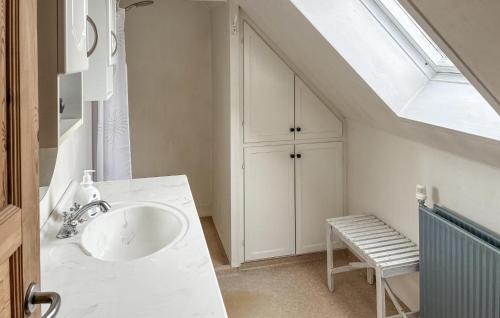 a bathroom with a sink and a skylight at Beautiful Home In Dannemare With Wifi in Dannemare