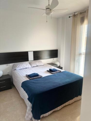 a bedroom with a bed with two towels on it at La Isla Bonita in Daimuz