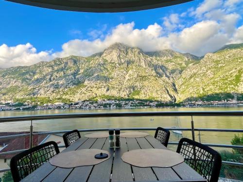 a table on a boat with a view of the mountains at Kotorscapes in Muo