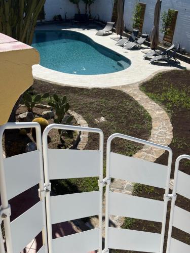 a swimming pool with chairs in a yard at Villa Gabry in Capo dʼOrlando