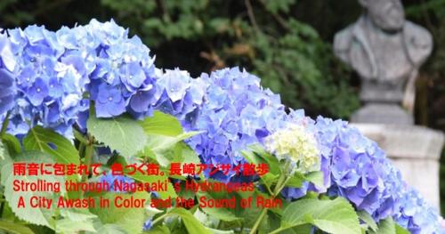 a bunch of blue flowers in front of a statue at Oyado Kinokuniya Daikokumachi in Nagasaki