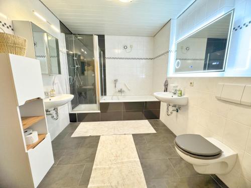 a bathroom with a toilet and a sink at 95qm Komfort & Natur Pur in Werdohl