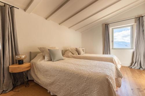 une chambre avec deux lits et une fenêtre dans l'établissement Jolie maison en plein coeur des bois et lavande pour 5 personnes, à Teyssières