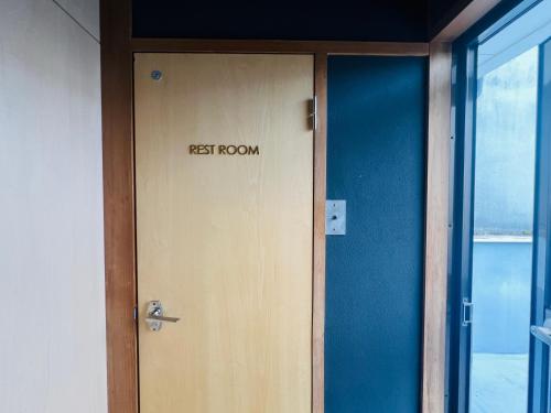 a restroom door with the words rest room on it at SIMA inn in Onomichi