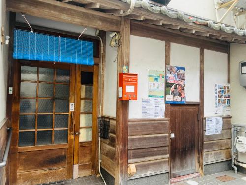 an entrance to a building with wooden doors at SIMA inn in Onomichi