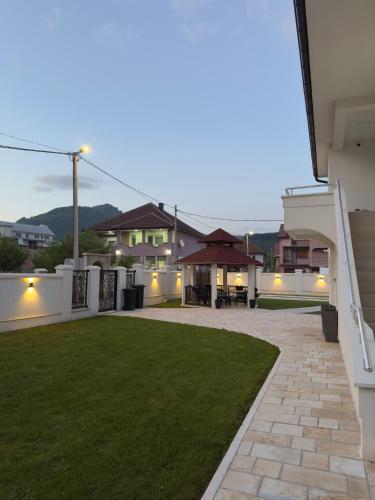a backyard of a house with a green lawn at Plav Serviced Apartments by Doni in Plav