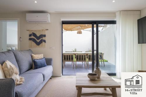 a living room with a couch and a table at 14th Street Villa - Espinho in Espinho