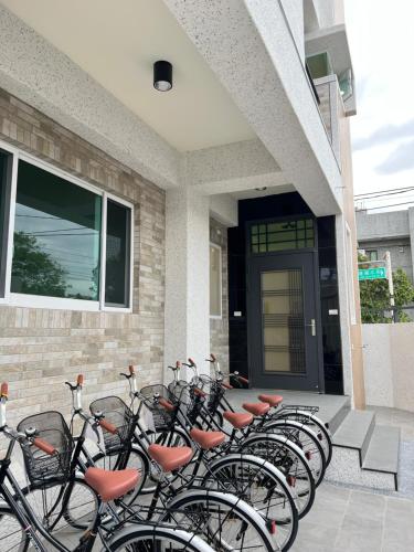 a row of bikes parked in front of a building at Bird Walking in Yuli