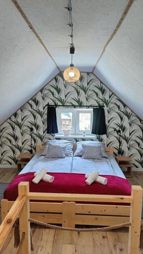 a bedroom with a large bed with a red blanket at Smerekowa Ostoja in Smerek