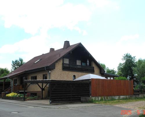 a house with a wooden fence in front of it at Ferienwohnung in Sponsheim in Bingen am Rhein