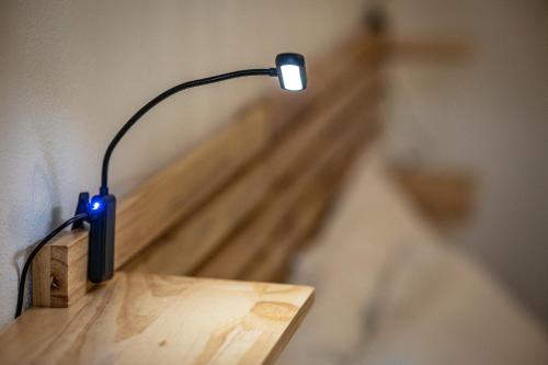 a lamp sitting on top of a wooden table at Case Vacanze Il Marchetto in Ottava Sassari