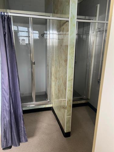 a walkin shower with glass doors in a bathroom at Green Hayes Estate Rentals - R 2 Magnolia House in Temuka