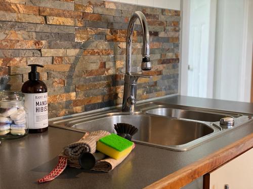 a kitchen counter with a sink and a sink at 2 Bedroom Apartment in Island Paradise in Sandnessjøen