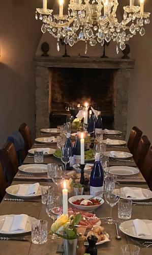 a long table with plates of food and candles at Relais la Corte di Lequio in Lequio Berria