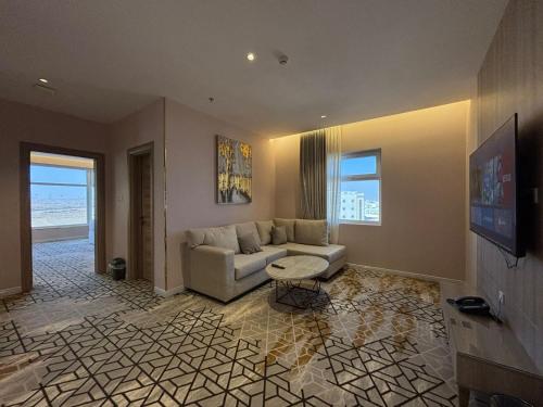 a living room with a couch and a table at Grand Line Hotel in Tabuk