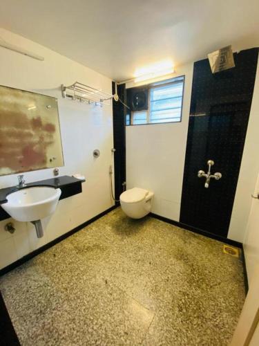 a bathroom with a sink and a toilet in it at Calangute Beach Way in Calangute