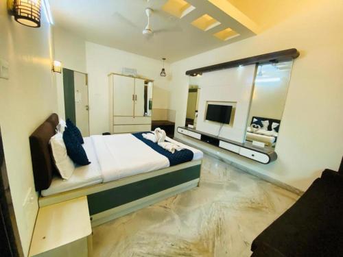 a bedroom with a large bed and a large window at Calangute Beach Way in Calangute