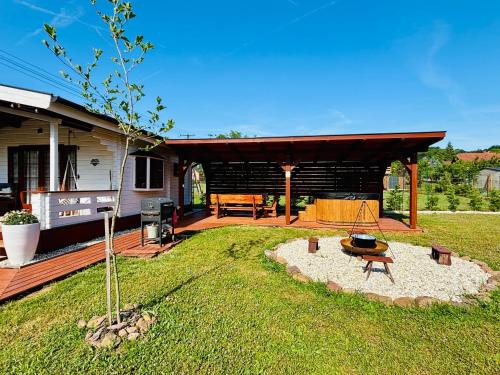 a backyard with a fire pit and a house at Szivike Vendégház in Ábrahámhegy