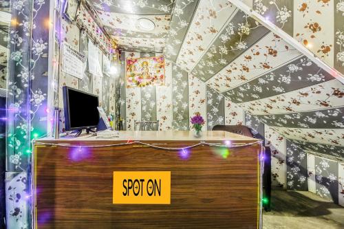 a desk with a computer on it with christmas lights at SPOT ON Hotel Aman Palace in Bhopal