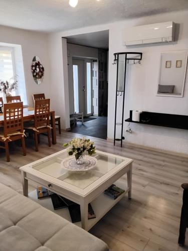 a living room with a couch and a table at Apartamentai KINTAI in Kintai