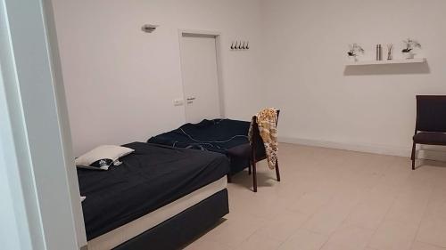 a bedroom with a bed and a chair in it at 吴民宿 in Bergisch Gladbach