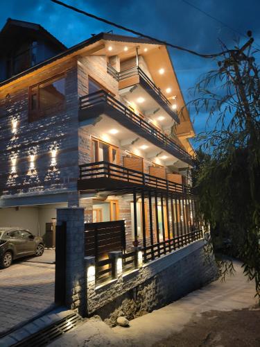 a house with lights on the front of it at The Alpine Escape, Manali in Manāli